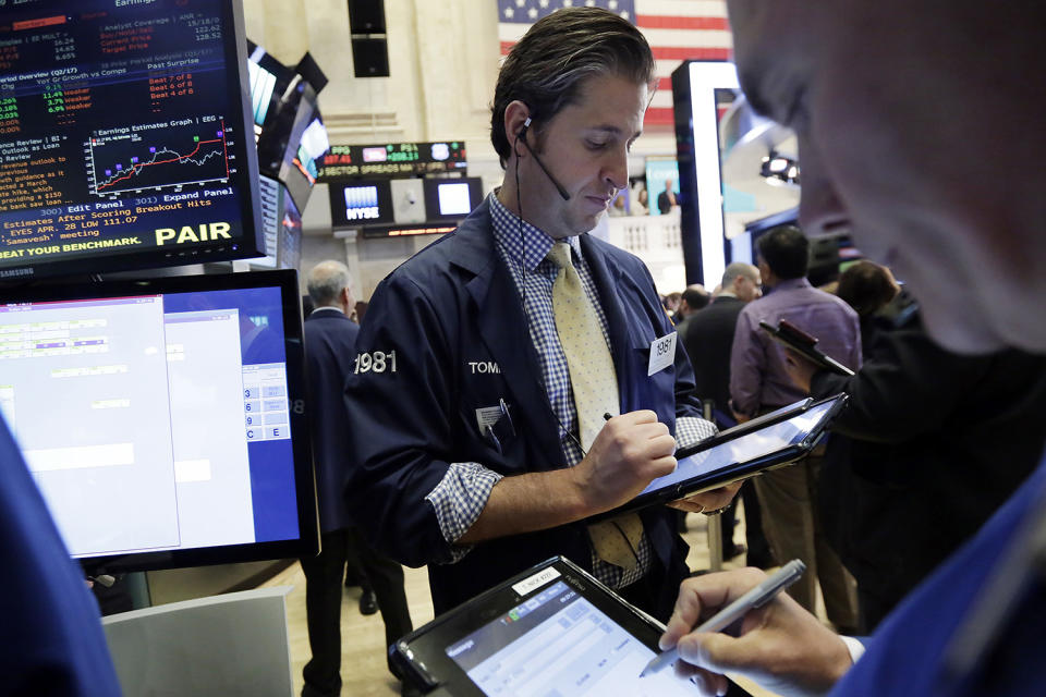 <p>Trader Thomas Donato, center, works on the floor of the New York Stock Exchange, May 17, 2017. Stocks are opening lower on Wall Street as banks and industrial companies fall. (Photo: Richard Drew/AP) </p>