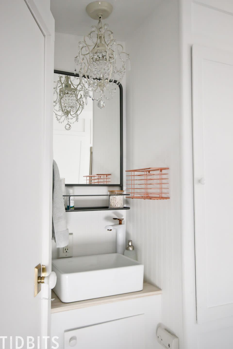 small bathroom storage ideas, shelved mirror and wire cubby in the white bathroom