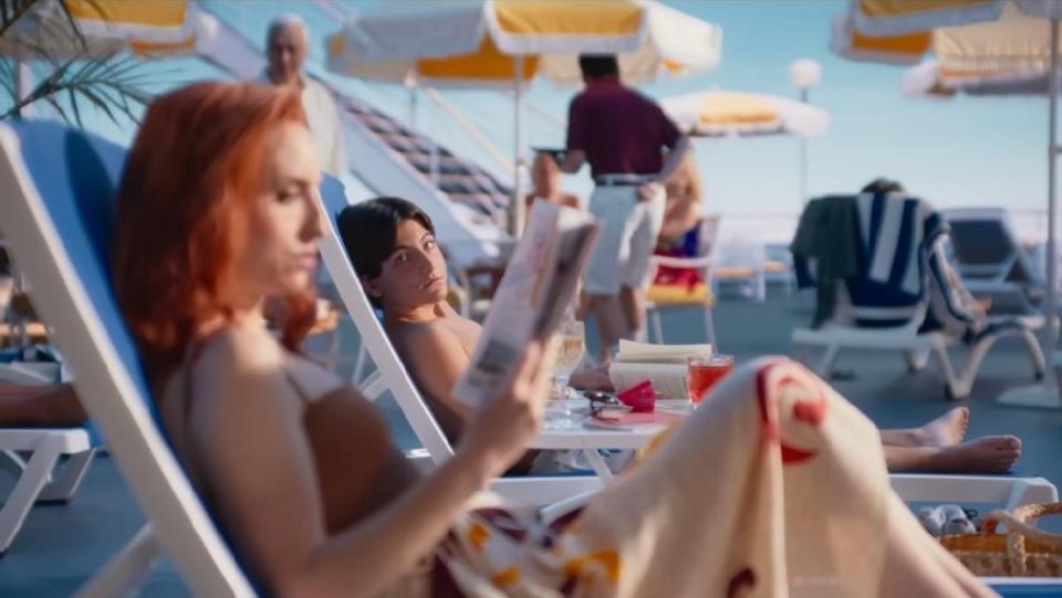 Zoe-Lister Jones reads on a magical looking cruise ship in Beau Is Afraid.