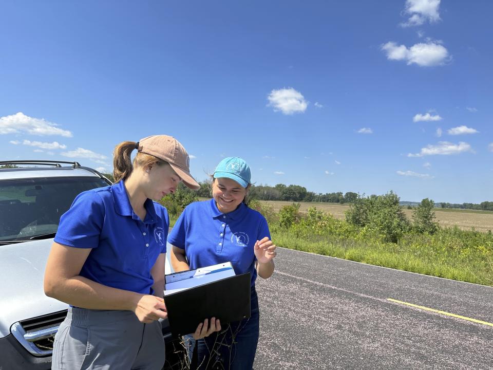 University of Wisconsin-Madison senior Arianna Barajas, center, talks to Crane Foundation fellow Alicia Ward, left, on Tuesday, Aug. 15, 2023, near Baraboo, Wis. Barajas, who identifies as Mexican-American, is spending the summer working for the International Crane Foundation as part of the Natural Resources Foundation of Wisconsin's Diversity in Conservation Internships. (AP Photo/Todd Richmond)