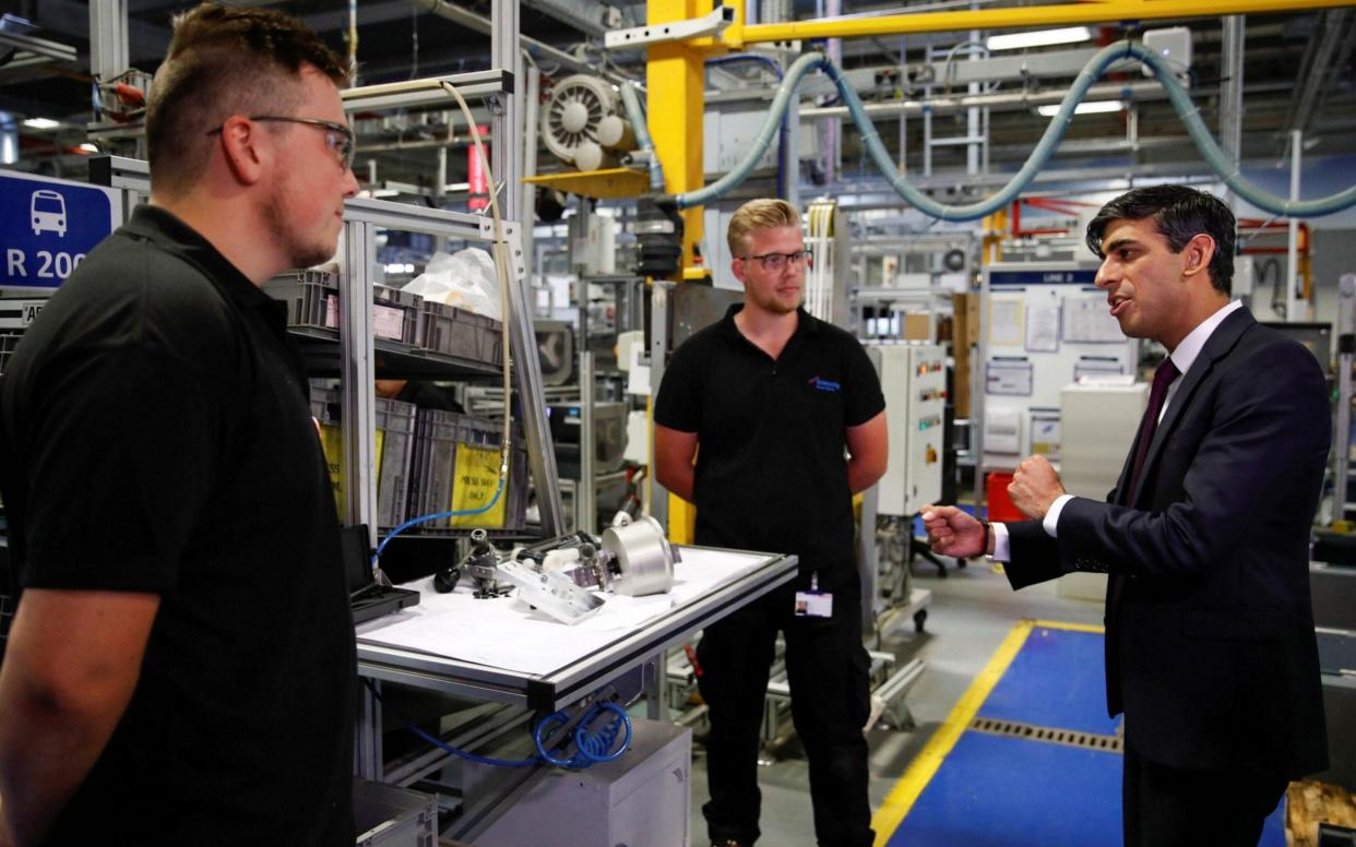 Chancellor of the Exchequer Rishi Sunak (R) speaks to employees during a visit to the Worcester Bosch factory in Worcester, central England, on July 9, 2020 - Phil Noble/AFP