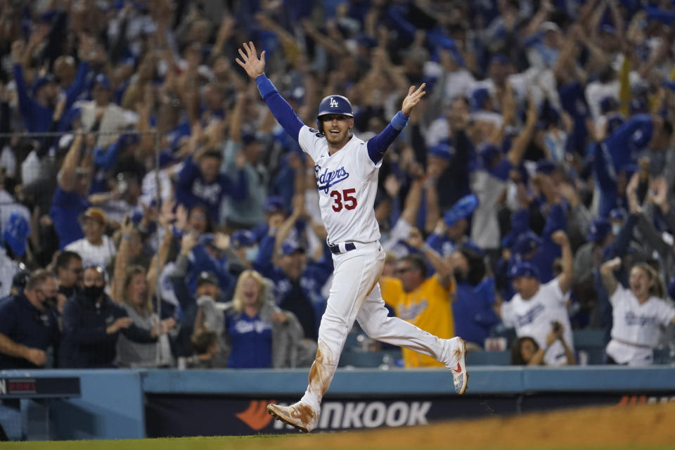 Los Angeles Dodgers center fielder Cody Bellinger (35) celebrates as he scores off of a home run hit by Chris Taylor during the ninth inning to win a National League Wild Card playoff baseball game 3-1 over the St. Louis Cardinals Wednesday, Oct. 6, 2021, in Los Angeles. (AP Photo/Marcio Jose Sanchez)