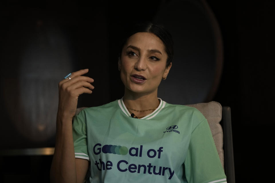 Nadia Nadim gestures as she speaks during an interview with The Associated Press in Doha, Qatar, Thursday, Dec. 1, 2022. Danish women's national team player Nadia Nadim was about to settle in for her job as a television commentator at the World Cup when she was shaken by tragic news: Her mother, who had helped the family flee the Taliban when Nadim was just a girl, had been hit by a car while rushing home to watch her daughter on TV. (AP Photo/Hassan Ammar)