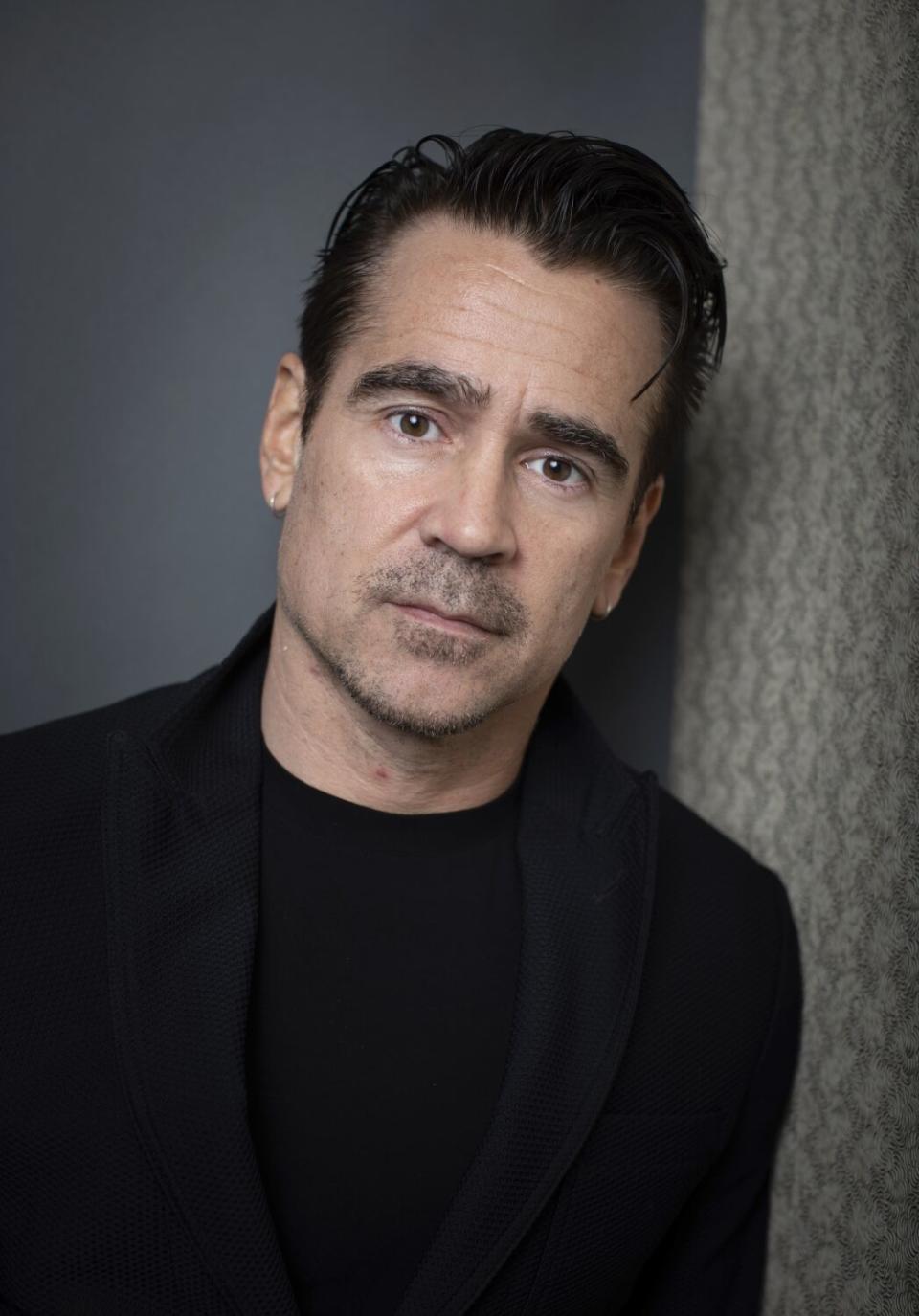 Colin Farrell wears a black sweater for a portrait.