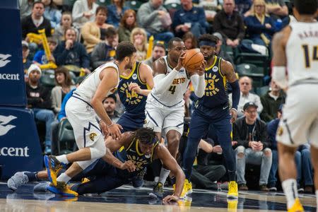 Mar 24, 2019; Indianapolis, IN, USA; Denver Nuggets forward Paul Millsap (4) comes up with a loose ball that Indiana Pacers center Myles Turner (33) dove for in the second half at Bankers Life Fieldhouse. Mandatory Credit: Trevor Ruszkowski-USA TODAY Sports