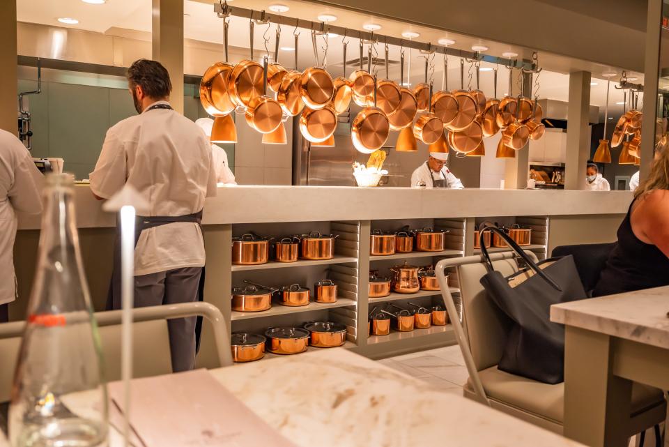 view from inside the bedford with tons of copper pots hanging above the kitchen area