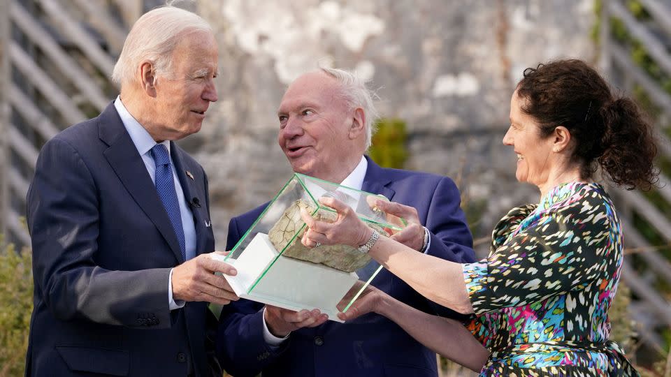 US President Joe Biden receives a brick from the fireplace from the home of his Irish relatives as he visits County Mayo, Ireland, in April 2023. Biden is one of four US presidents who descended from Irish famine immigrants. - Kevin Lamarque/Reuters