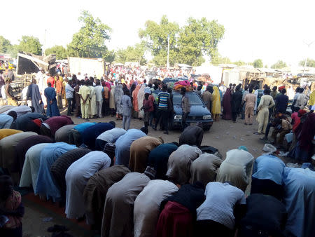 People are seen praying as others fleeing the town of Baga arrive to Maiduguri, Nigeria, December 29, 2018. REUTERS/Ahmed Kinngimi