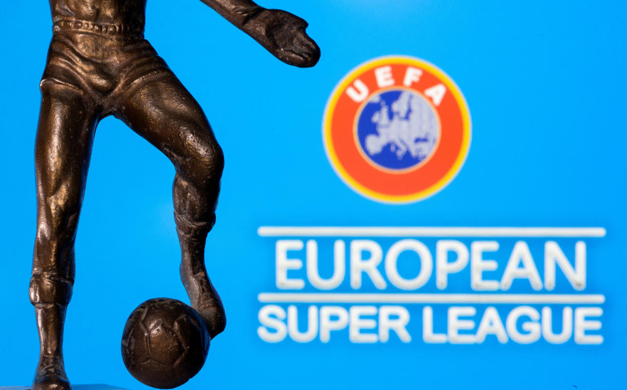 FILE PHOTO: A metal figure of a football player with a ball is seen in front of the words 