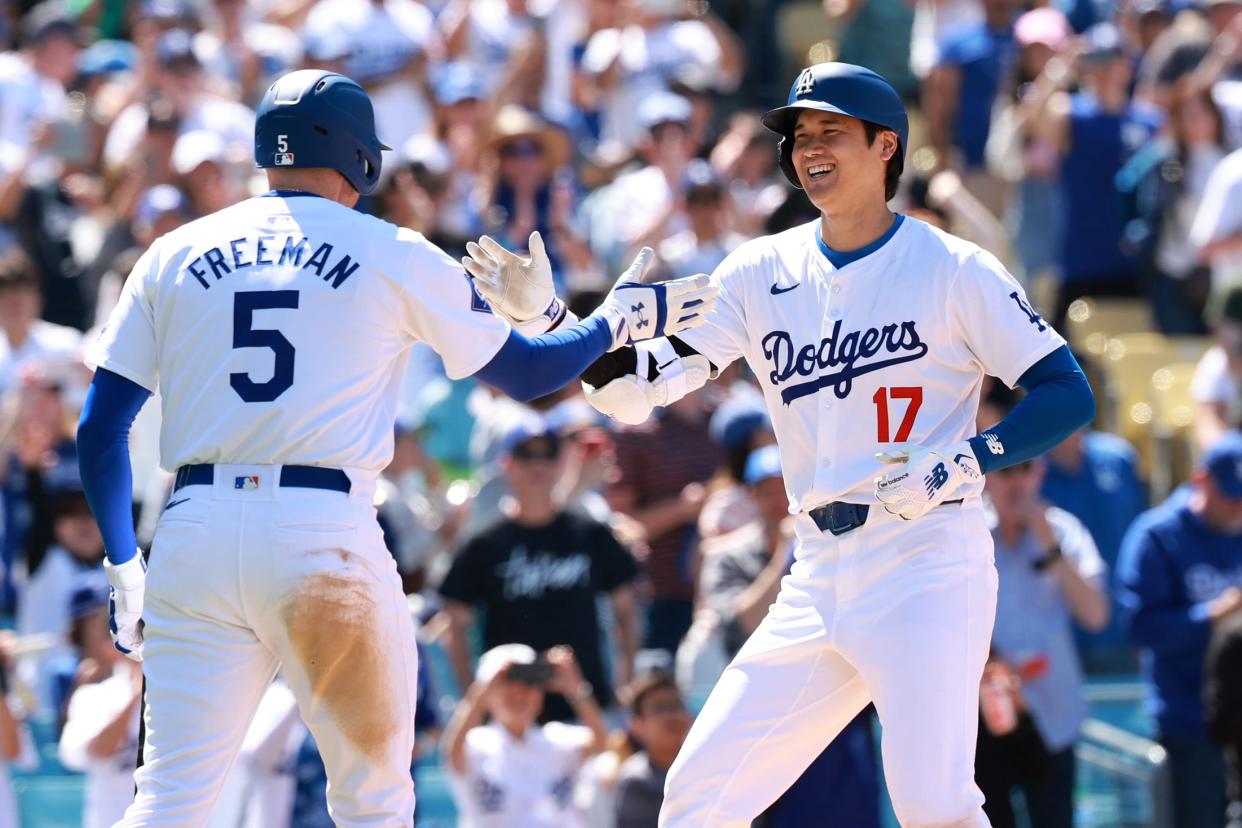 Shohei Ohtani is greeted by Freddie Freeman after a home run against the Braves.