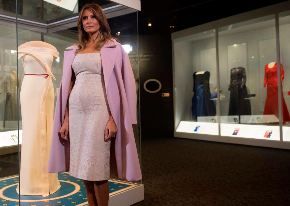 First lady Melania Trump stands alongside the gown she wore to the 2017 inaugural balls as she donates the dress to the Smithsonian's First Ladies Collection at the National Museum of American History in Washington, DC, Oct. 20, 2017.