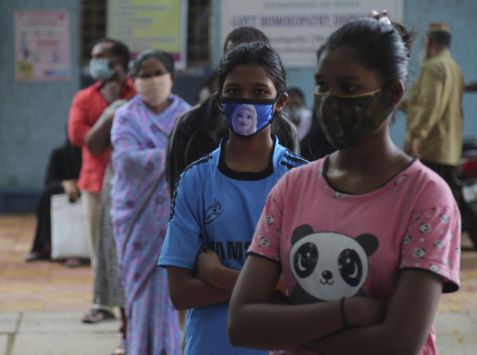 People wait in a queue give their nasal swab samples to test for COVID-19 in Hyderabad, India, Saturday, Aug. 22, 2020. India has the third-highest caseload after the United States and Brazil, and the fourth-highest death toll in the world. (AP Photo/Mahesh Kumar A.)