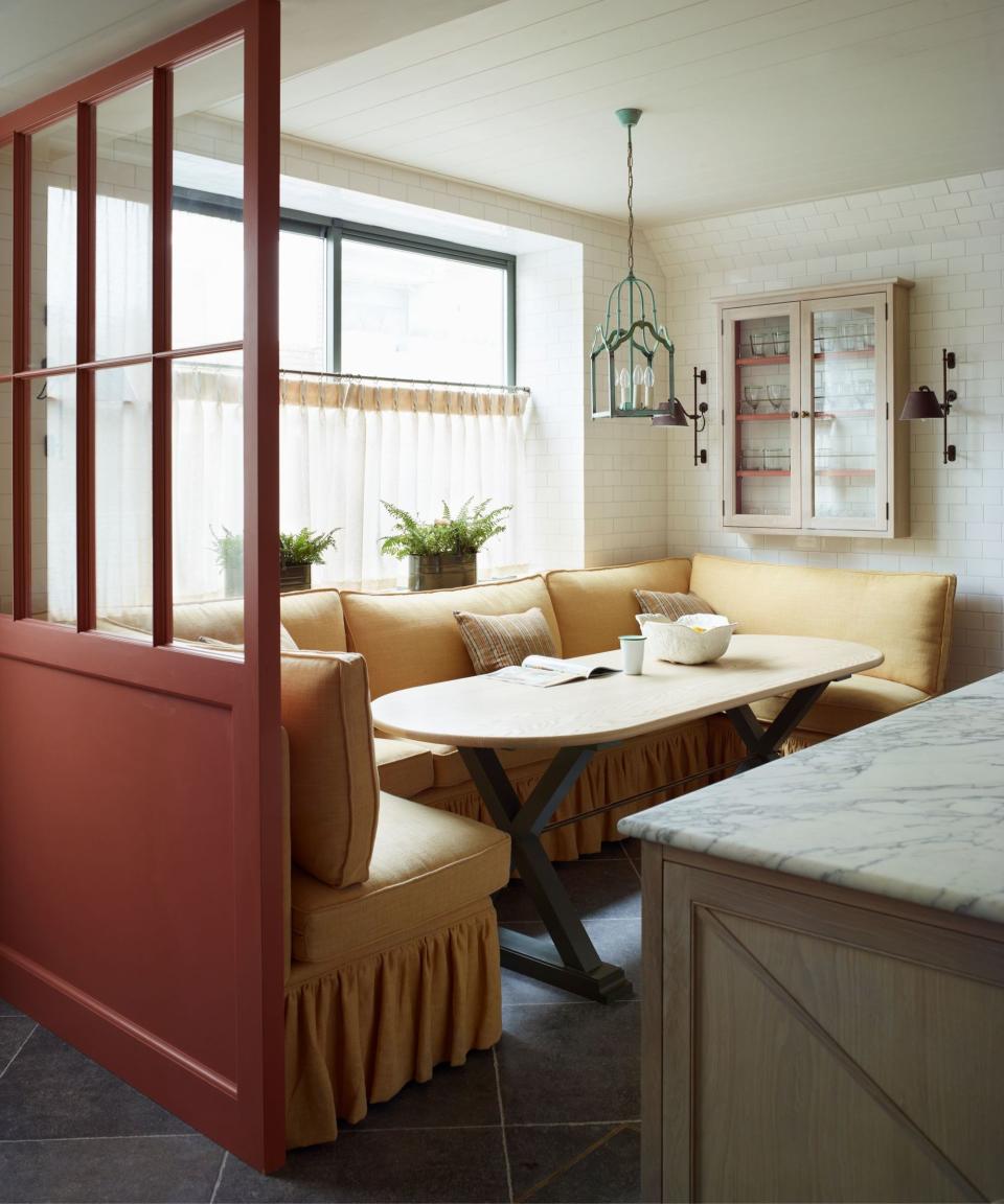 Dining banquette in yellow around dining table