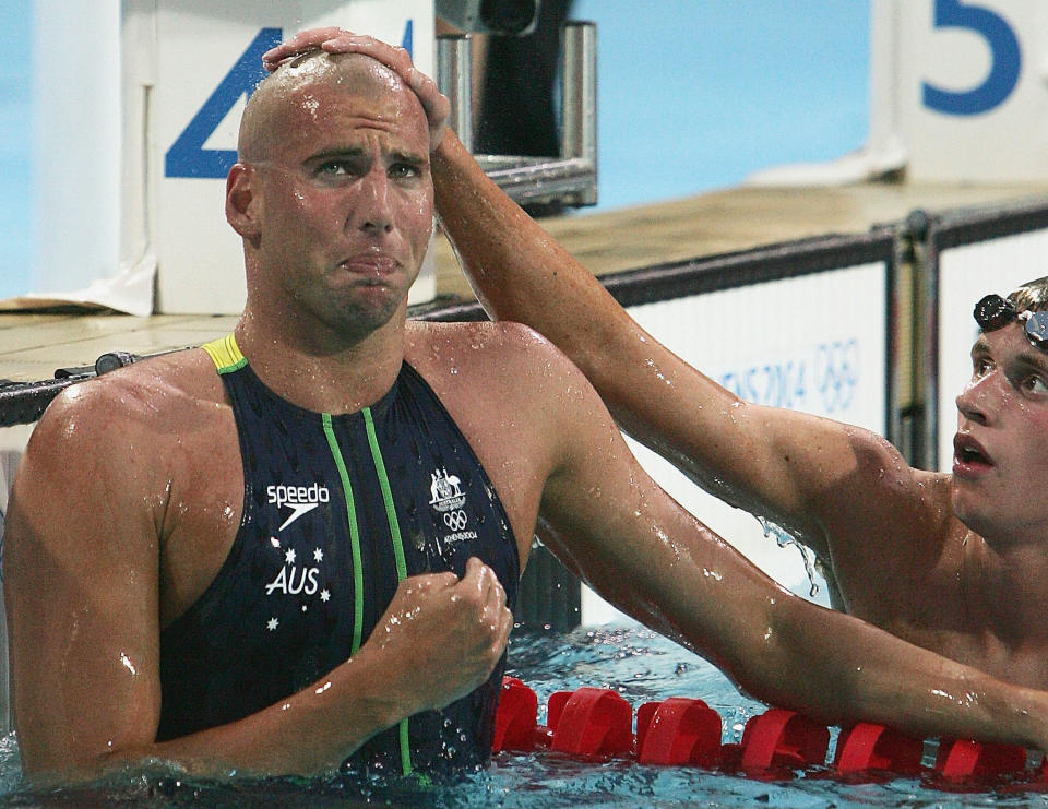 ATHENS - AUGUST 21: Grant Hackett (L) of Australia cries after winning the gold medal as bronze medalist David Davies of Great Britain congratulates him after swimming in the men's swimming 1500 metre freestyle final on August 21, 2004 during the Athens 2004 Summer Olympic Games at the Main Pool of the Olympic Sports Complex Aquatic Centre in Athens, Greece. (Photo by Stuart Hannagan/Getty Images)