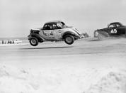 FILE - Red Farmer (61) is airborne after hitting a hole on the four mile Daytona Beach road course during the 100-mile Modified and Sportsmen type stock car race in Daytona Beach, Fla., Feb. 14, 1953. Farmer will be inducted into the NASCAR Hall of Fame at ceremonies in Charlotte, N.C., Friday, Jan. 21, 2022. (AP Photo/James P. Kerlin, File)