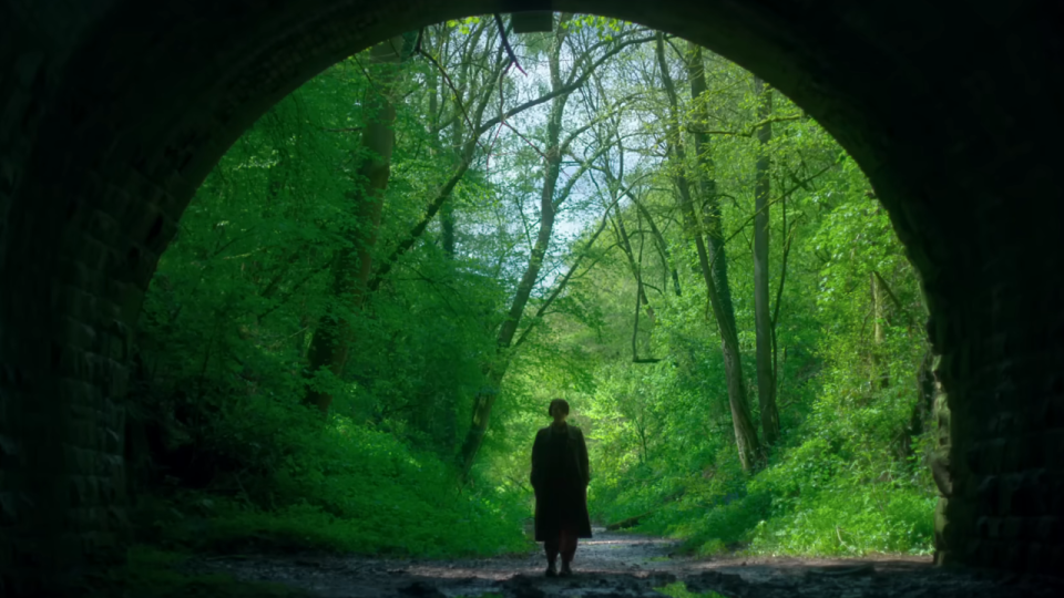 A woman starring into a tunnel in Men.