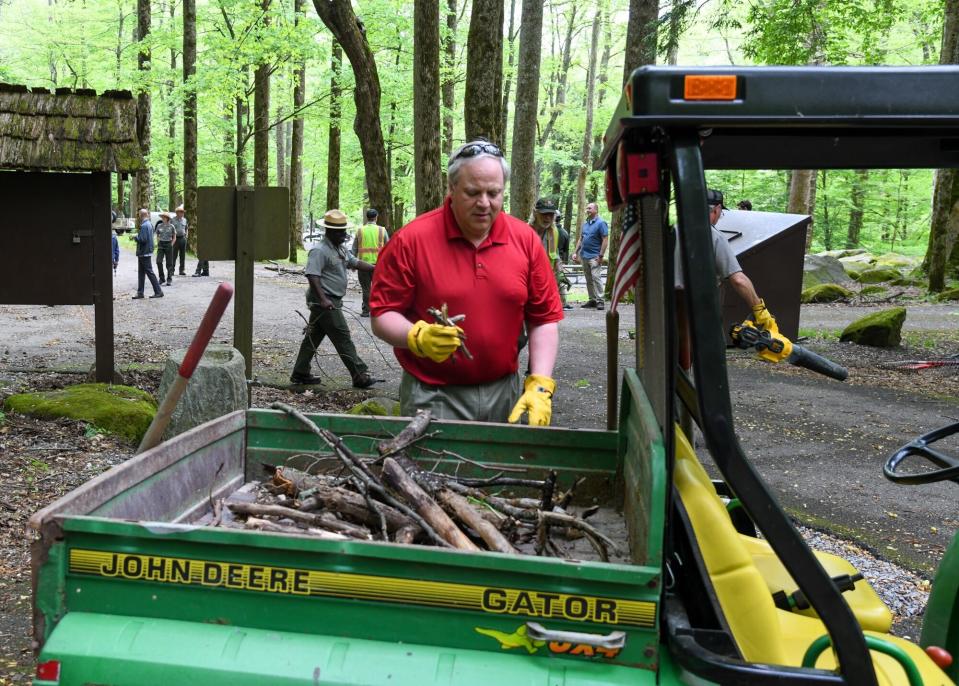 This Wednesday, May 6, 2020 image from a tweet by Interior Secretary David Bernhardt, the Interior Secretary visits with National Parks Service employees at Great Smoky Mountains National Park. While the Interior Secretary asked visitors to social distance when the park reopens on May 9, neither Bernhardt nor park staff wore face masks in the photos, as they talked and walked inches apart during his visit on Tuesday, May 5. (National Parks Service via AP)