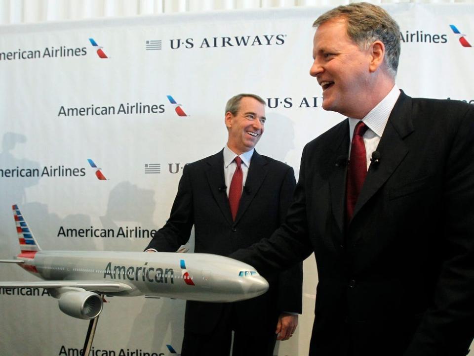 Then-CEO of US Airways Doug Parker and then-Chairman, president, and CEO of American, Tom Horton.