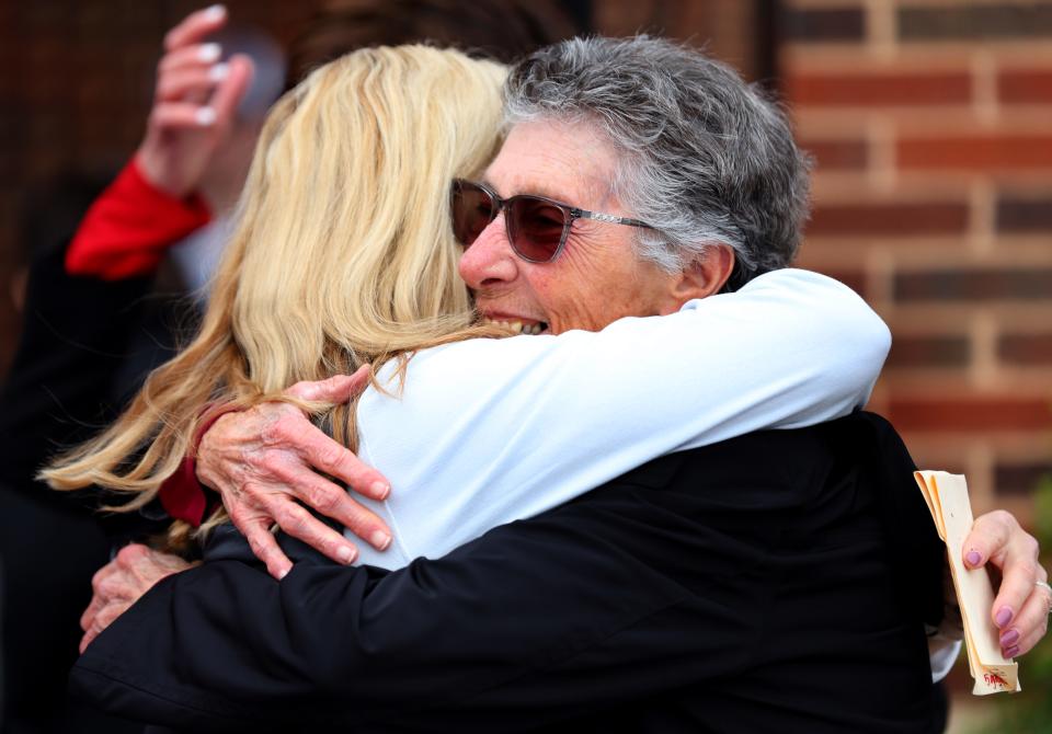 Marita Hynes hug Oklahoma softball head coach Patty Gasso during the grand opening of the the University of Oklahoma Love's Field softball stadium in Norman, Okla., Friday, March 1, 2024.