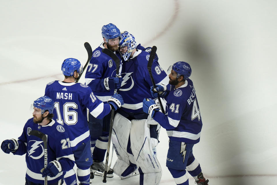 Tampa Bay Lightning goaltender Andrei Vasilevskiy, center, celebrates with teammates after Game 3 of the NHL hockey Stanley Cup Final against Colorado Avalanche on Monday, June 20, 2022, in Tampa, Fla. (AP Photo/Chris O'Meara)