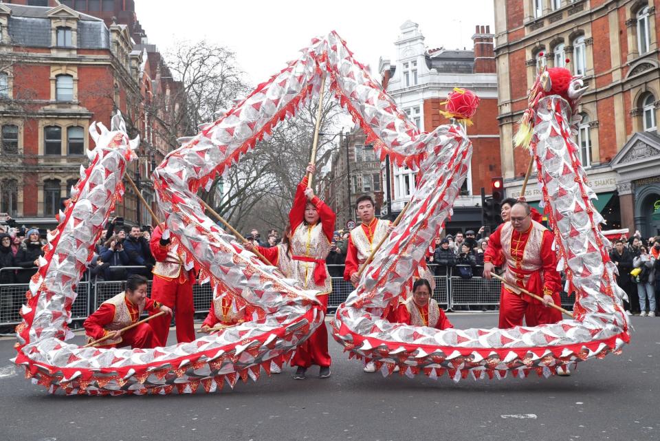 Performers taking part in a parade involving costumes, lion dances and floats, during Chinese New Year (PA)