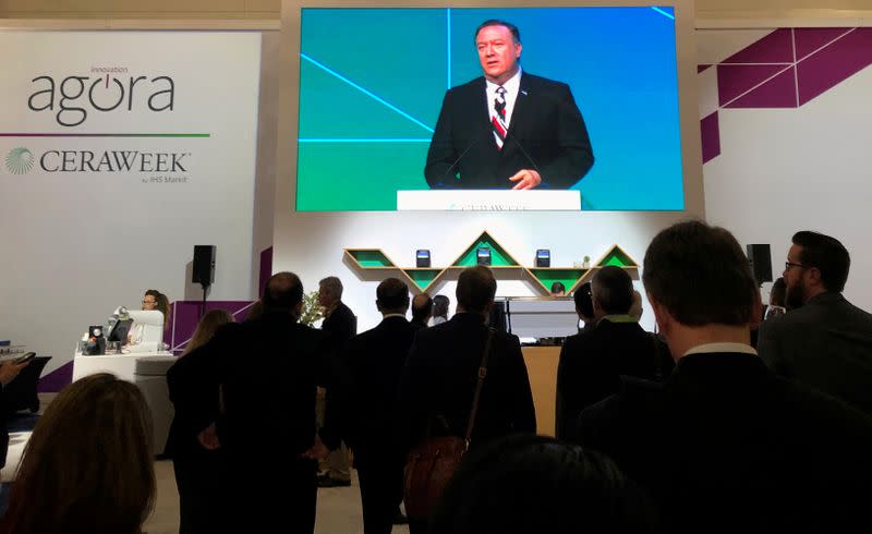 FILE PHOTO: Attendees at IHS Markit’s CERAWeek conference watch the keynote address by U.S. Secretary of State Mike Pompeo from the George Brown Convention Center in Houston