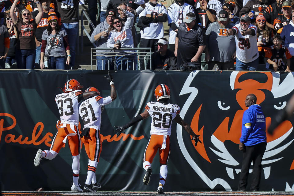 Nov 7, 2021; Cincinnati, Ohio, USA; Cleveland Browns cornerback Denzel Ward (21) reacts with safety Ronnie Harrison (33) and cornerback Greg Newsome II (20) after scoring a touchdown in a game against the Cincinnati Bengals in the first half at Paul Brown Stadium. Mandatory Credit: Katie Stratman-USA TODAY Sports