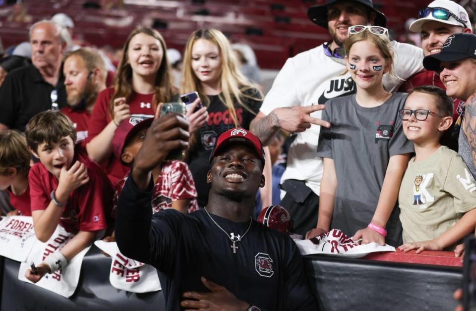 South Carolina wide receiver Nyck Harbor (8) takes photos with fans during the Gamecocks’ Garnet & Black game at Williams-Brice Stadium in Columbia on Saturday, April 20, 2024.