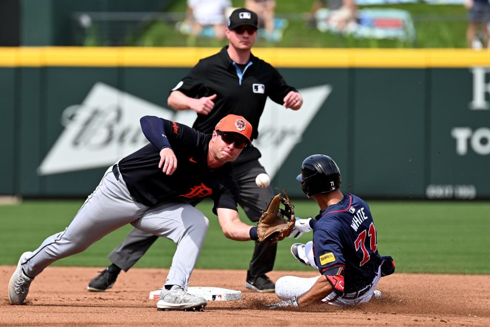 Detroit Tigers second baseman Colt Keith (33) catches the ball as Atlanta Braves left fielder Forrest Wall (73) slides into second base in the second inning of the spring training game at CoolToday Park on March 5, 2024, in North Port, Florida.