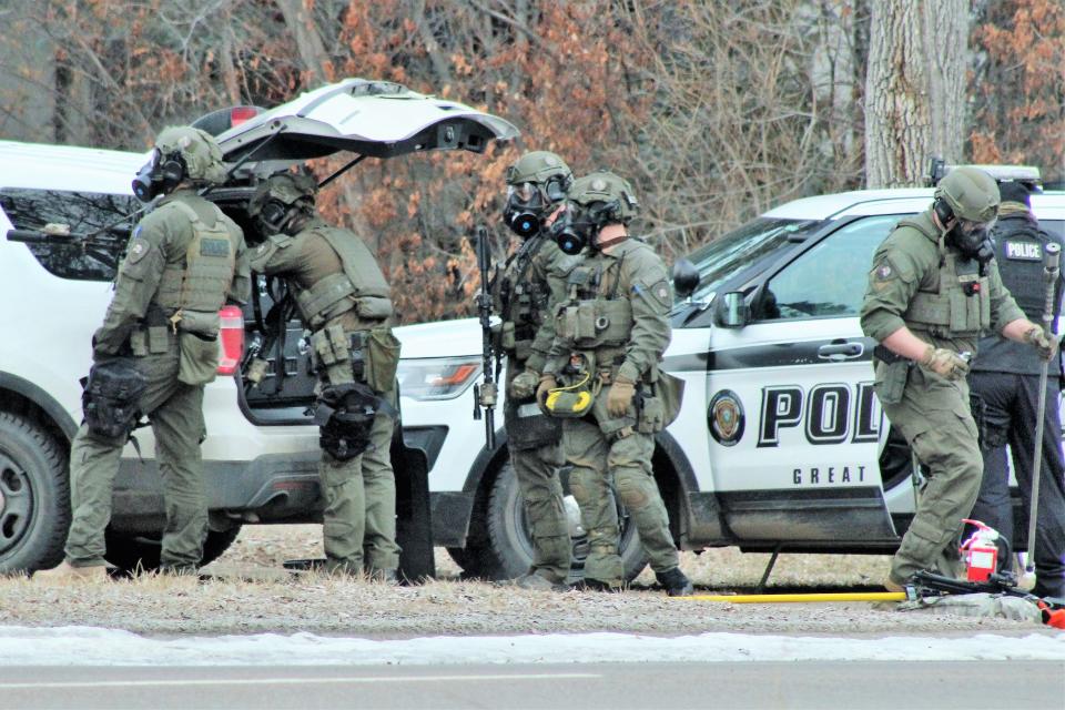 A portion of the Great Falls Police Department's tactical unit prepares outside the house at 2812 1st Ave. North where Monday's standoff took place.