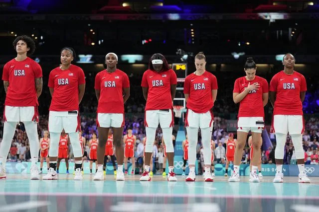 <p>Jesse D. Garrabrant/NBAE via Getty</p> Team USA stands for the National Anthem before the game against Team Japan on July 29, 2024