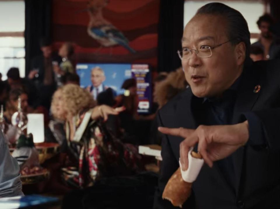 Yo-Yo Ma, right, during a party scene near the beginning of ‘Glass Onion' (Netflix)
