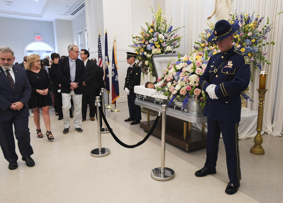 People file past the casket of former Louisiana Gov. Kathleen Blanco during a visitation at St. John's Cathedral Hall, Friday, Aug. 23, 2019, in Lafayette, La. Blanco, who served one term as governor and various elected positions across two decades, was in Louisiana’s top job during the destruction of hurricanes Katrina and Rita in 2005. She died a week earlier from cancer. (Brad Kemp/The Advocate via AP)