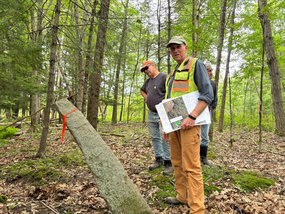 Christopher Mende (foreground), vice president of surveying with Civil Consultants in South Berwick, led a formal perambulation of the disputed border between Kittery and York on Monday, June 24, 2024. Behind Mende are Todd Frederick (left), the chairperson of the York Select Board, and the board's vice chairperson Robert Palmer Jr.