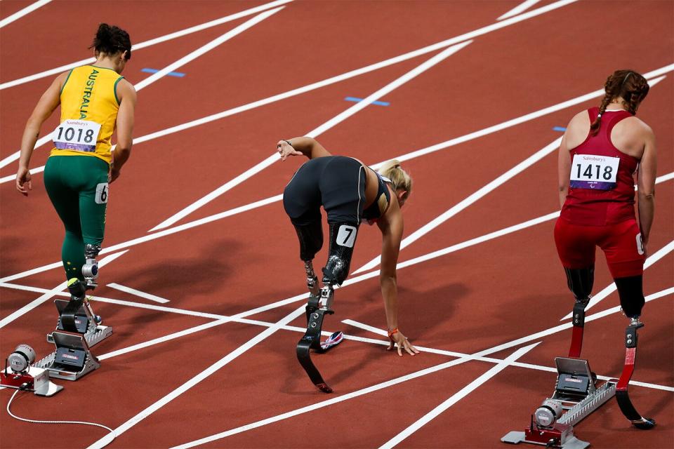 L-R; Australia's Kelly Cartwright, Germany's Vanessa Low, and USA's Katy Sullivan go through their different starting techniques prior to the start of the women's 100m T42 at the Olympic stadium, London (Photo by EMPICS Sport - PA Images via Getty Images)