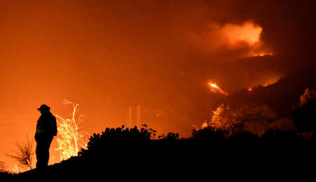 Firefighters keep watch on the Thomas wildfire in the hills and canyons outside Montecito, California, U.S., December 16, 2017. REUTERS/Gene Blevins