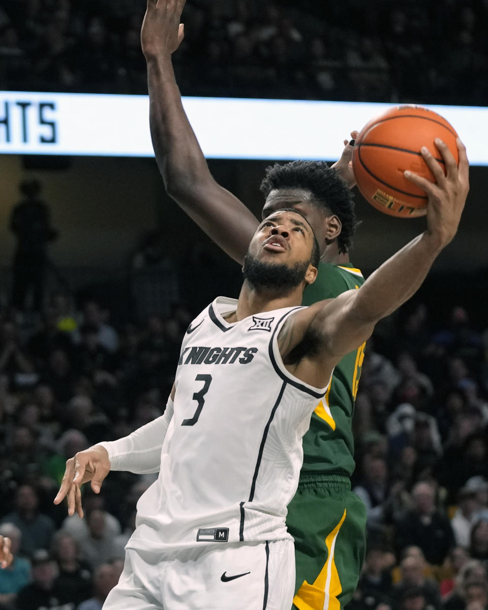 Central Florida guard Darius Johnson (3) makes a shot in front of Baylor forward Josh Ojianwuna during the second half of an NCAA college basketball game, Wednesday, Jan. 31, 2024, in Orlando, Fla. (AP Photo/John Raoux)