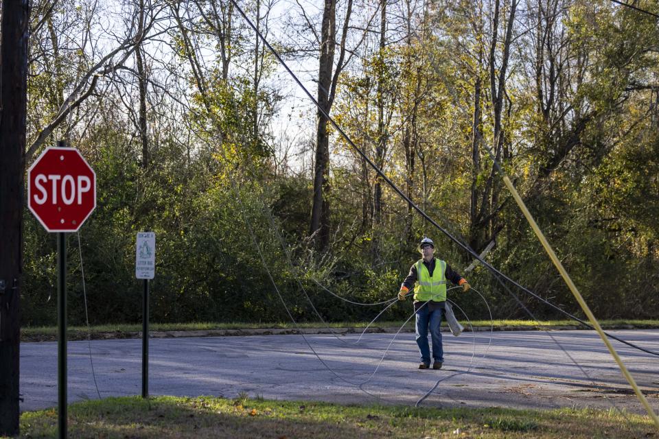 Utility workers repair power lines in the aftermath from Tuesday's severe weather, Wednesday, Nov. 30, 2022, in Eutaw, Ala. (AP Photo/Vasha Hunt)