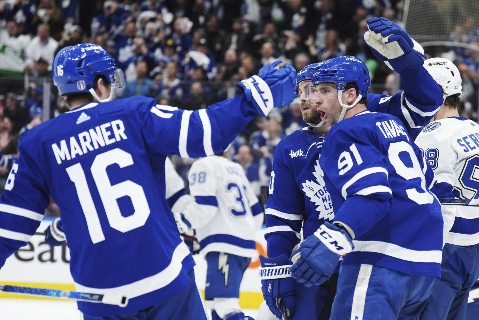 Toronto Maple Leafs forward Ryan O'Reilly celebrates his goal against the Tampa Bay Lightning with Mitchell Marner (16) and John Tavares (91) during the second period of Game 1 of a first-round NHL hockey playoff series Tuesday, April 18, 2023, in Toronto. (Nathan Denette/The Canadian Press via AP)