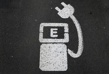 FILE PHOTO - A battery charger sign for electric cars is painted on the ground of a parking ground near the soccer stadium in Wolfsburg, Germany, in this April 6, 2016 file photo. REUTERS/Kai Pfaffenbach/File Photo