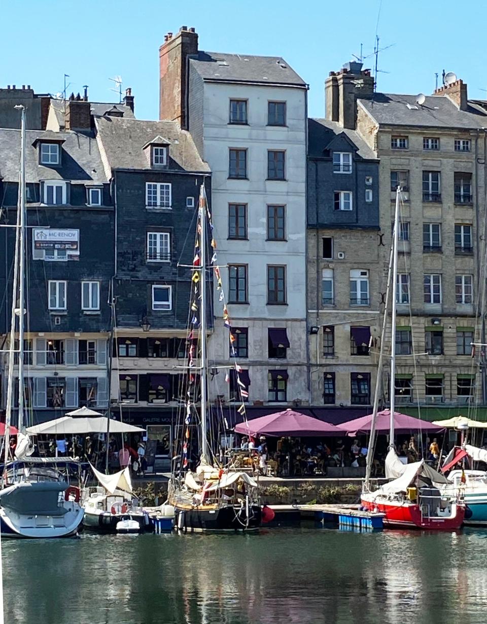 Homes and boats in Honfleur, France. Homeowners on the bottom two floors have access to the marina and owners of the top four or five floors enter from the street side behind these buildings.