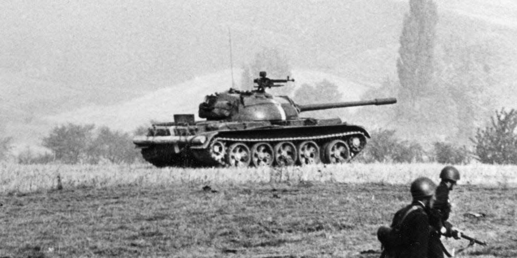 Soviet soldiers march forward alongside T-54 tanks during a training exercise in October 1965.