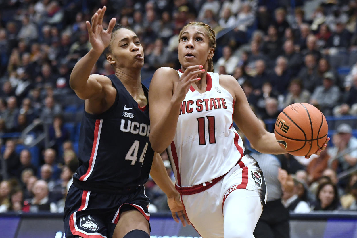 NC State's Jakia Brown-Turner drives to the basket as UConn's Aubrey Griffin defends during their game on Nov. 20, 2022. (AP Photo/Jessica Hill)