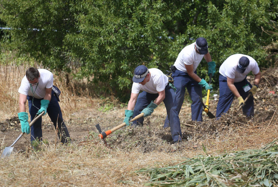 British police officers in 2014 clearing an area of wasteland during the search for evidence in the town of Praia da Luz (Picture: PA)