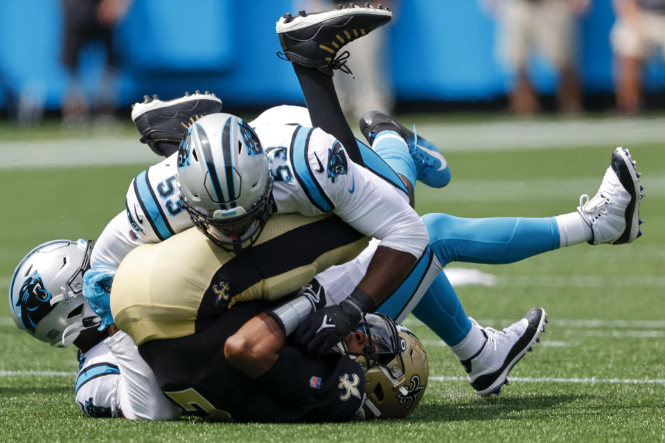 New Orleans Saints quarterback Jameis Winston is sacked by Carolina Panthers defensive end Brian Burns (53) and outside linebacker Haason Reddick during the first half of an NFL football game Sunday, Sept. 19, 2021, in Charlotte, N.C. (AP Photo/Nell Redmond)