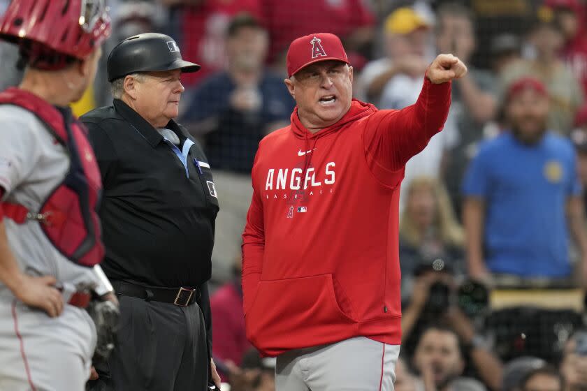 Angels manager Phil Nevin points and argues with home plate umpire Jerry Layne