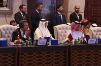 The delegations of Turkey and Qatar attend an international conference with western, regional and United Nations representatives aimed at resolving Libya's thorniest issues ahead of general elections planned for December, at the Coronthia Hotel in Tripoli, Libya, Thursday, Oct. 21, 2021. (AP Photo/Yousef Murad)