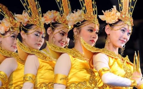 Dancers from the Central Ethnic Song and Dance Ensemble, perform the 'Thousand Hands of Guanyin' routine in Trafalgar Square, London - Credit: Fiona Hanson/PA