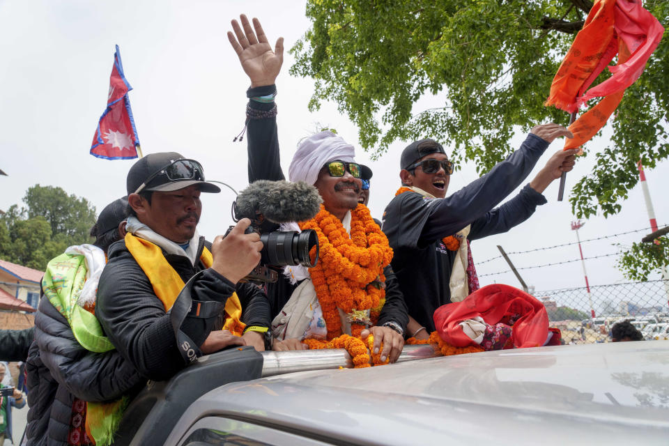 Hari Budha Magar, former Gurkha veteran and double amputee climber who scaled Mount Everest, is welcomed upon arrival at the airport in Kathmandu, Nepal, Tuesday, May 23, 2023. The former Gurkha veteran had lost both his legs in Afghanistan when he accidentally stepped on an improvised explosive device in 2010. Magar, who was a soldier in the Gurkha regiment, was born in a remote mountain village in Nepal and later was recruited by the British army. He now lives with his family in Canterbury, England. (AP Photo/Niranjan Shrestha)