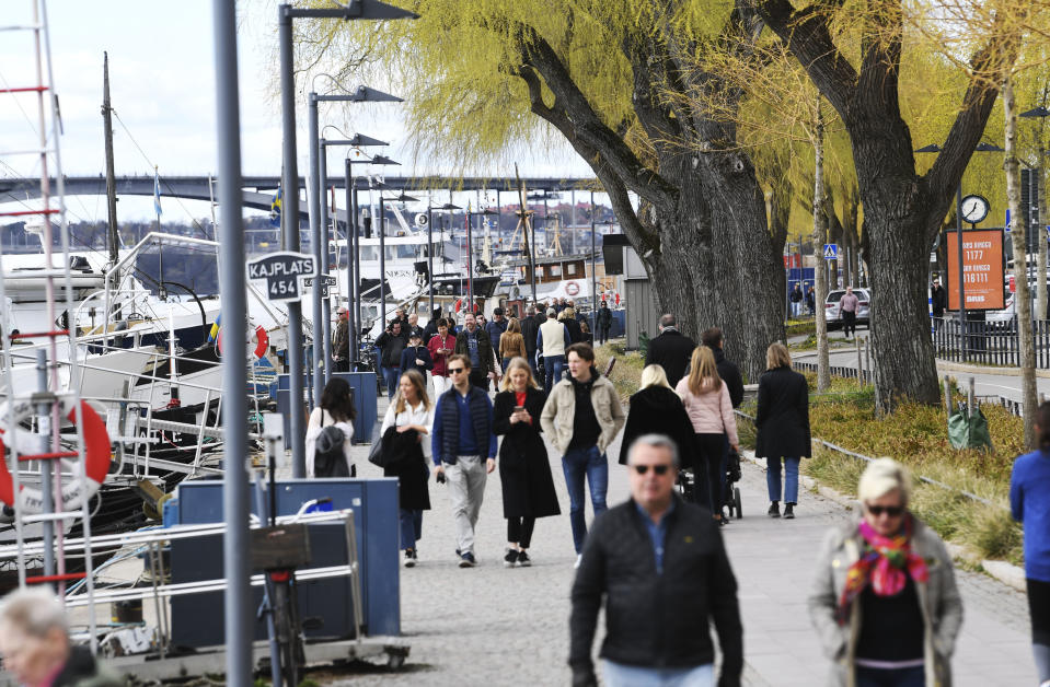 People take a stroll at Norr Mälarstrand street in Stockholm, Sweden, on April 19, 2020, amid the new coronavirus COVID-19 pandemic. (Photo by Fredrik SANDBERG / TT News Agency / AFP) / Sweden OUT (Photo by FREDRIK SANDBERG/TT News Agency/AFP via Getty Images)